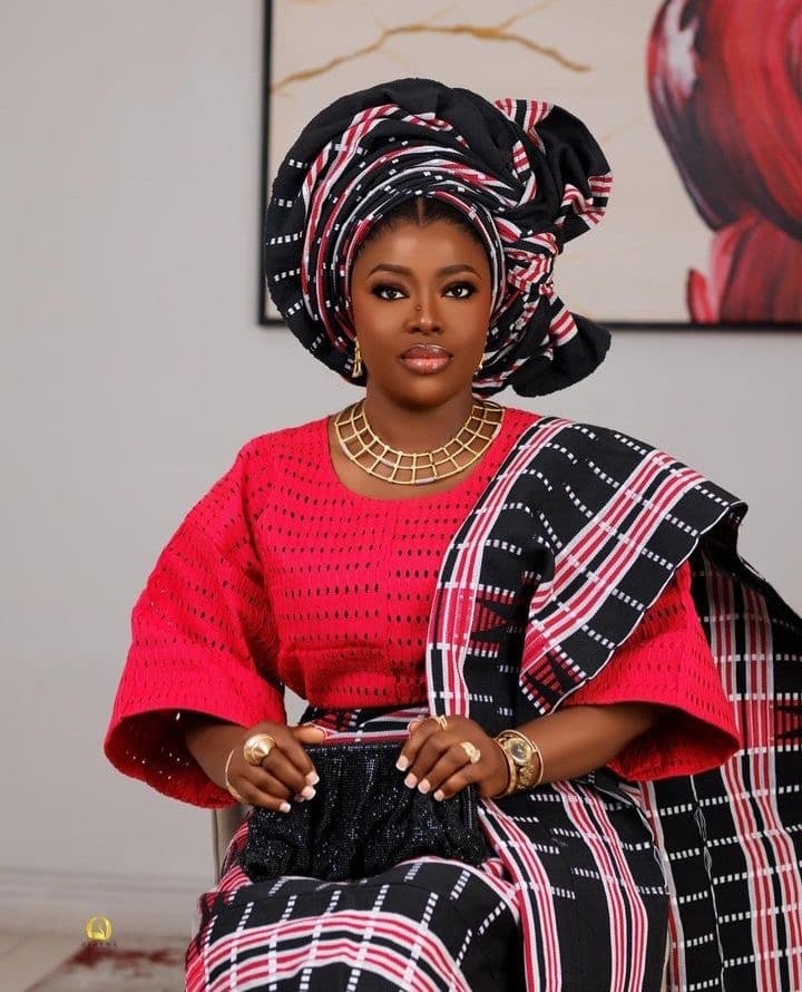 Woman in vibrant pink Nigerian traditional ensemble