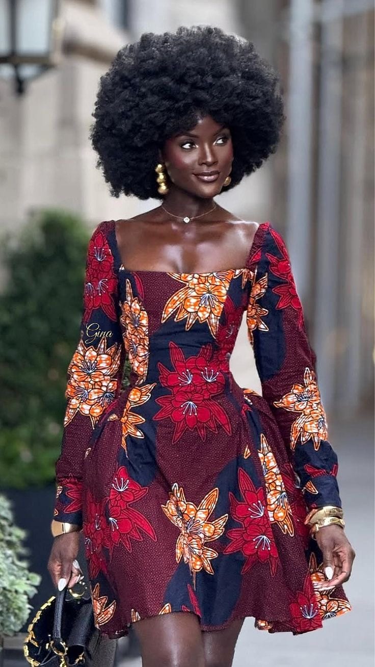 Woman wearing a vibrant floral African-print dress outdoors